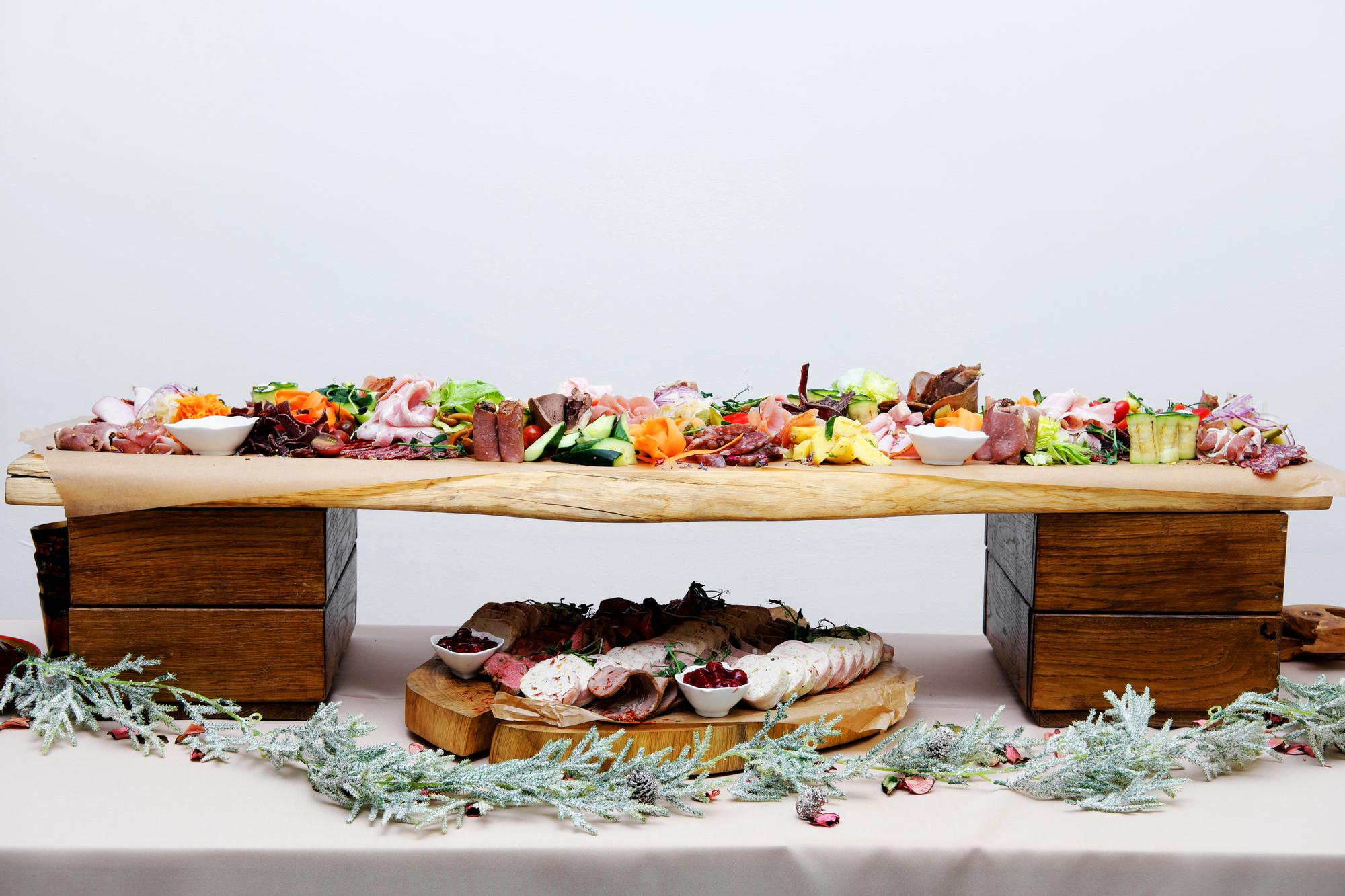 Large spread of prepared dishes on a wooden table